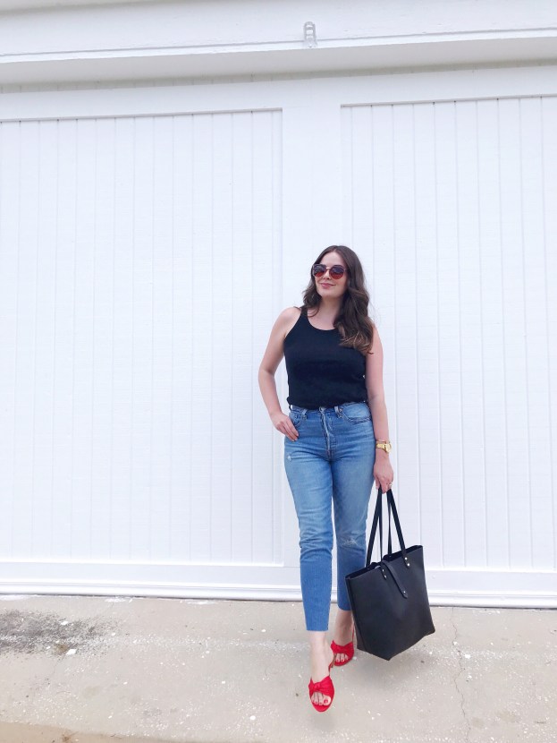 Style blogger wearing Levi's 501 skinny jeans with a black tank and red LOFT satin knot slide sandals